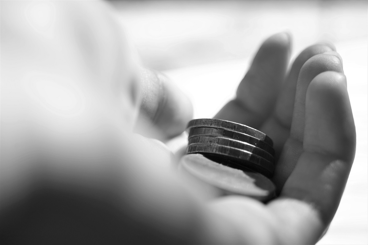 A pile of coins held within a hand.