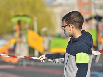 Child with facemaskin playground