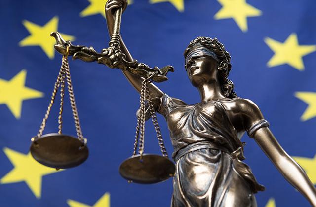 Lady justice with EU flag as background