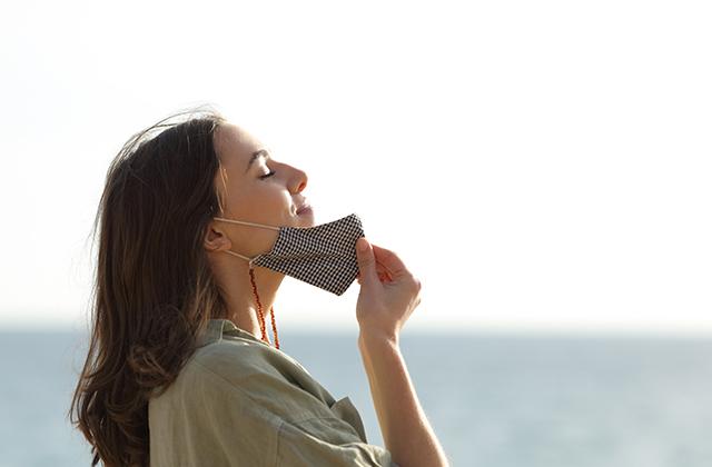 Woman removing a facemask