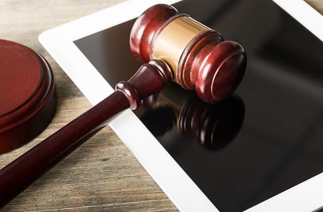 Gavel against a tablet