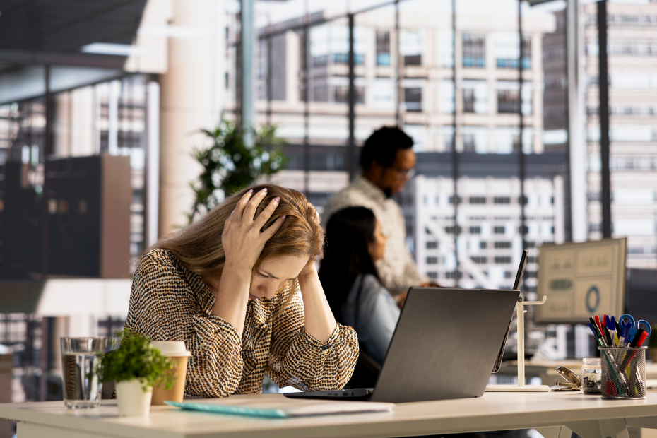 Stressed woman sitting at her office.