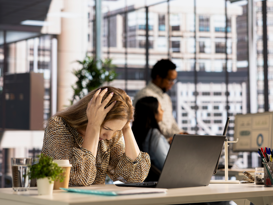 Stressed woman sitting at her office.